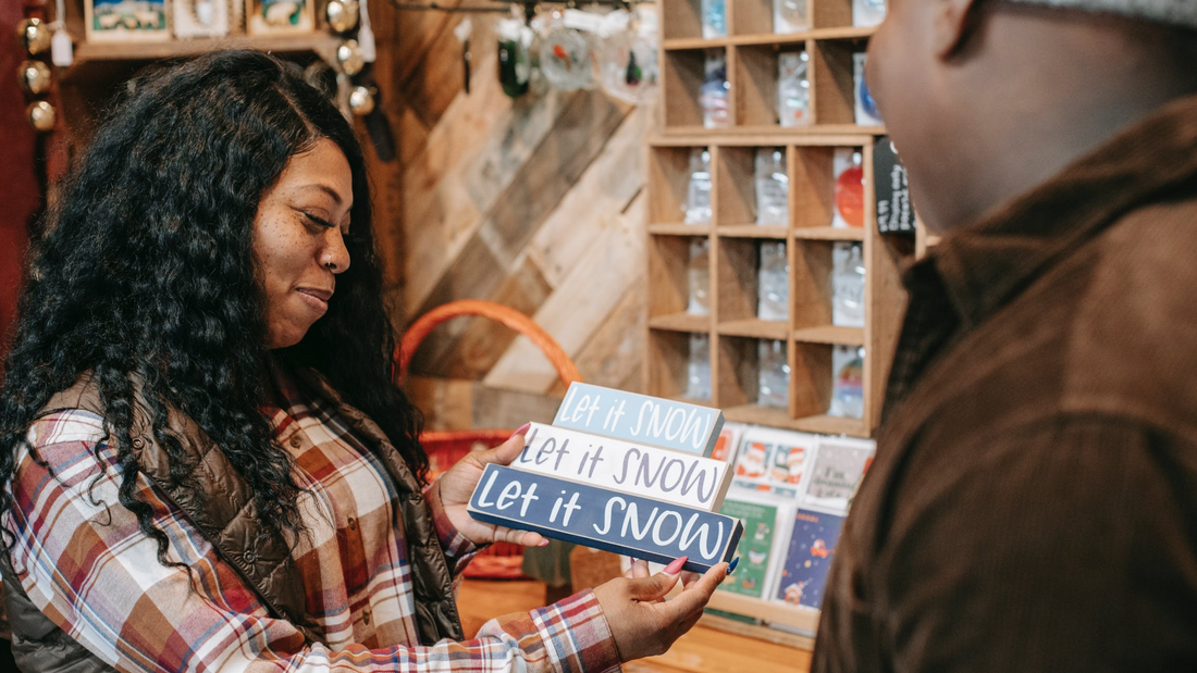 Black owned businesses to shop: black woman looking at Christmas sign